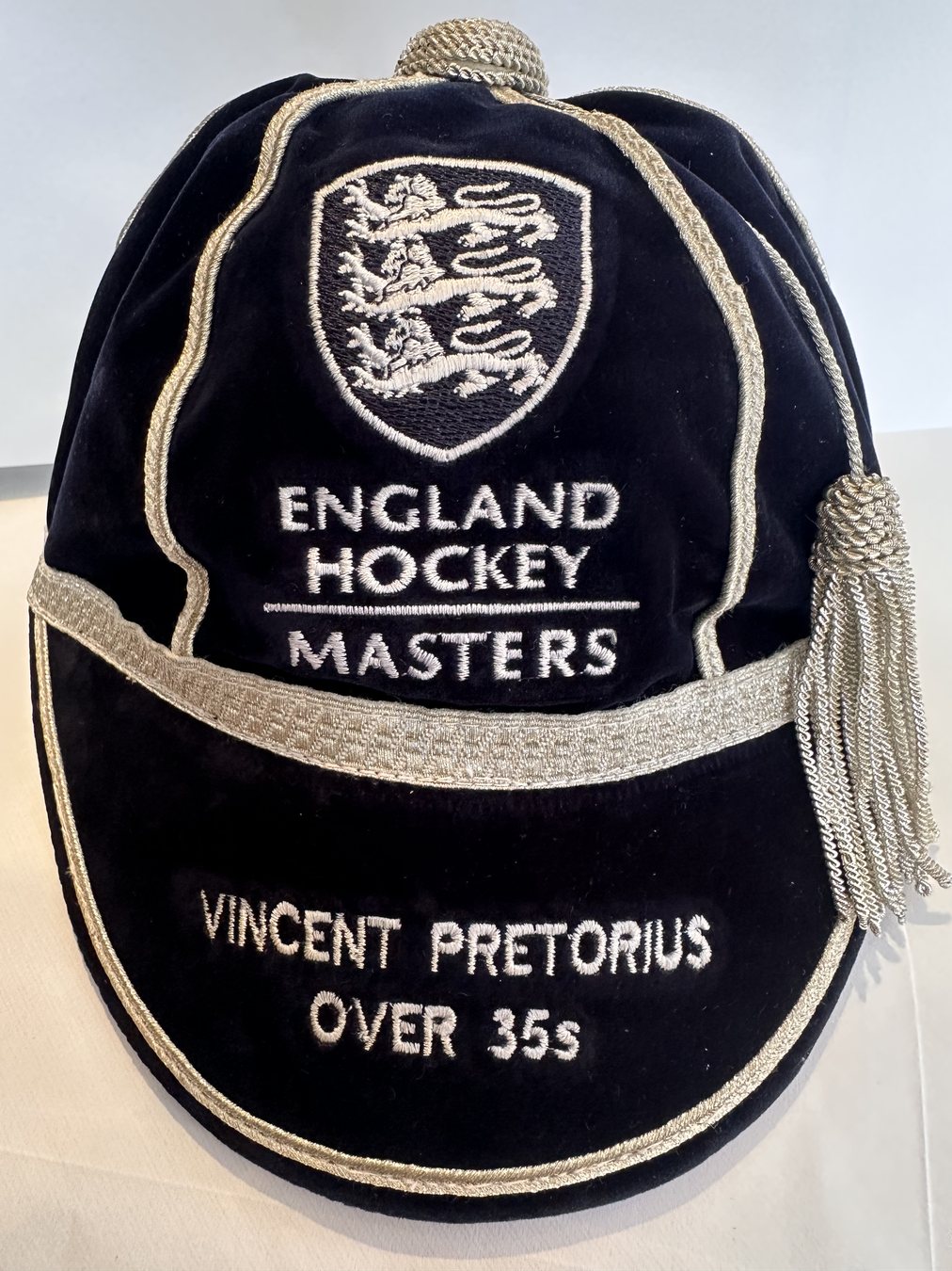 Navy velvet Masters honours cap with silver braid, tassel and embroidered peak